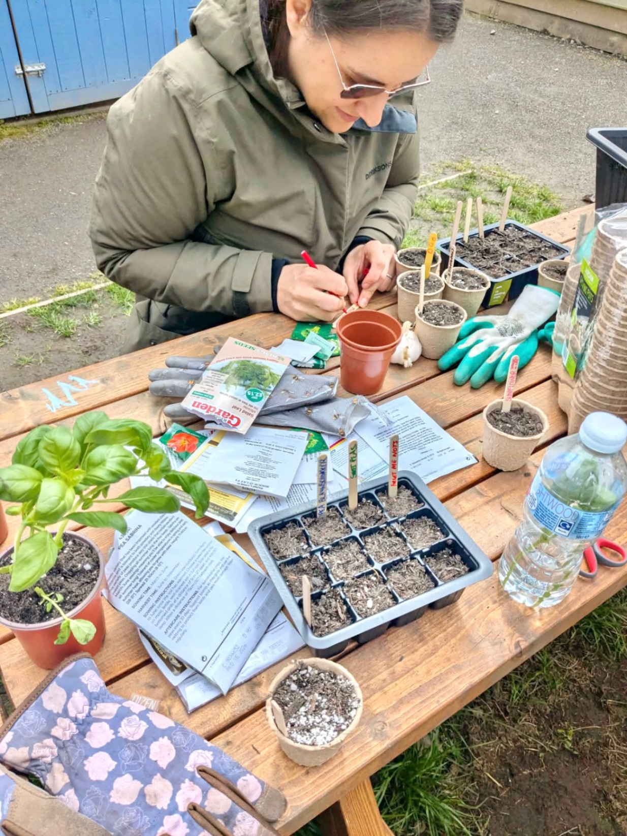 Pam from Balance and Bloom labelling seedlings during a therapeutic gardening workshop